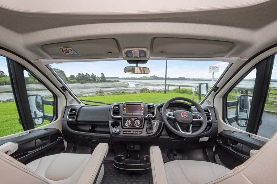 An automatic gearbox viewed from the motorhome's dining area with an estuary in the background