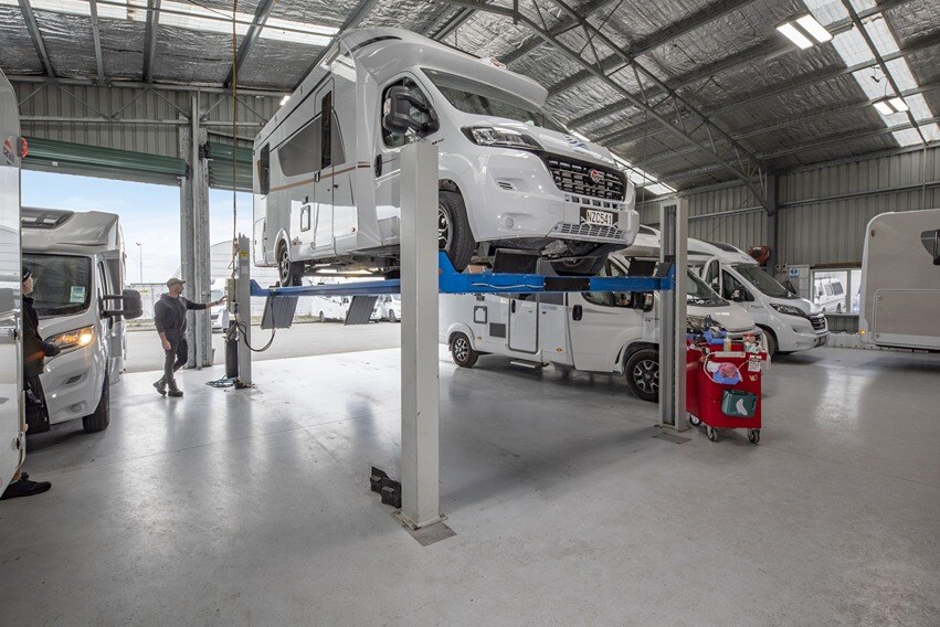 Motorhome hoisted up in a workshop