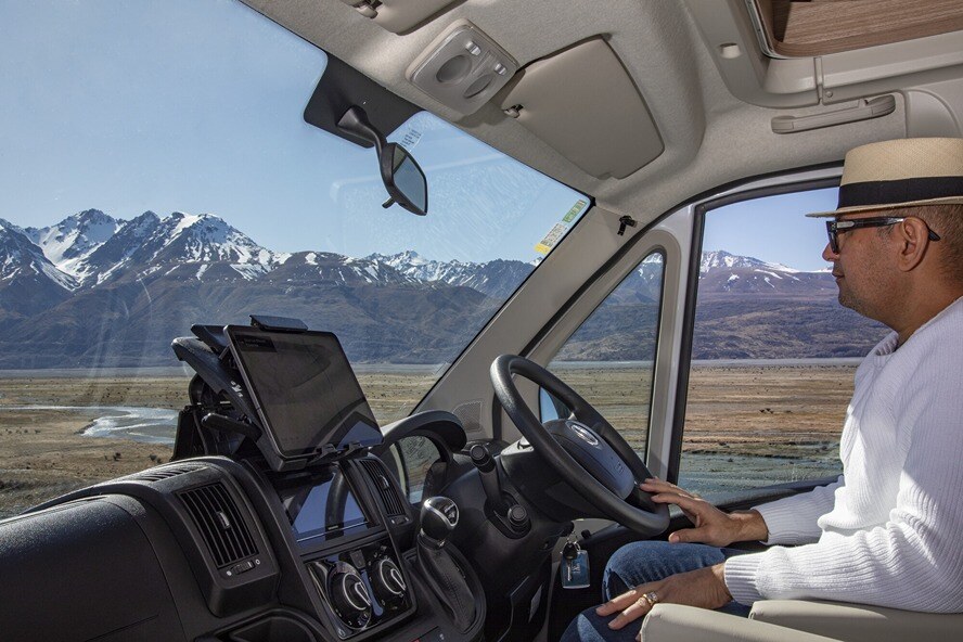 Side cab view with driver at the wheel