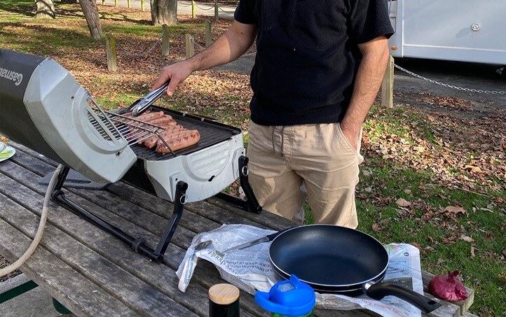 BBQ cooking sausages with gas