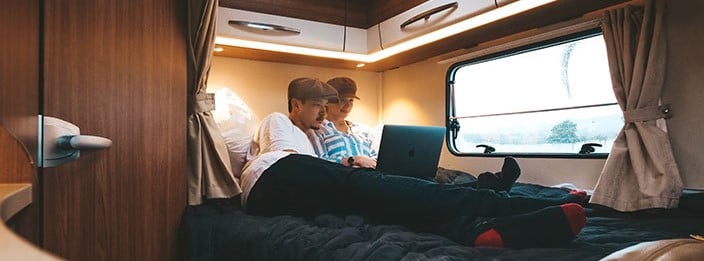 Couple relaxing in motorhome bed