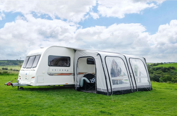 caravan with awning by actionoutdoors.kiwi
