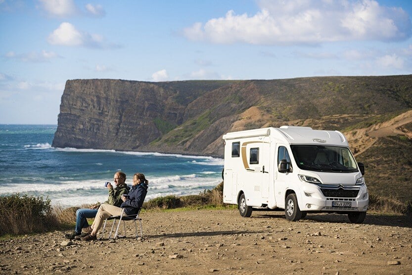 Couple enjoying coffee outside Carado V337 2018 in Portugal