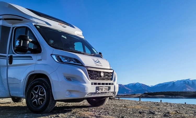 A Carado motorhome parked up beside a lake
