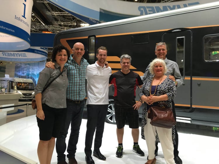 Wilderness team and MCD editor pose in front of a Hymer motorhome prototype