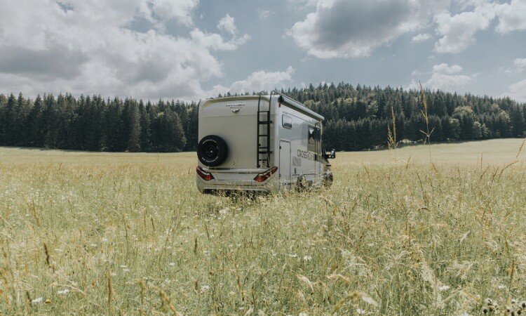 A HYMER Crossover 4x4 motorhome being driven in a field