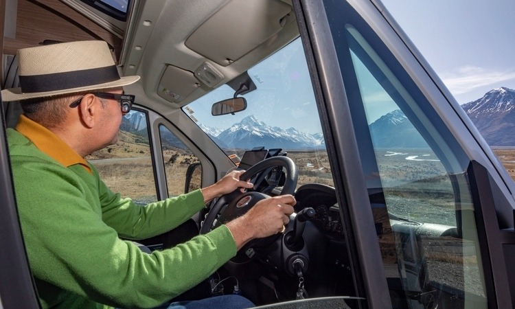 A man driving a motorhome in the outdoor