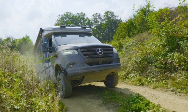 Heavy duty HYMER four wheel drive motorhome being driven in rough terrain