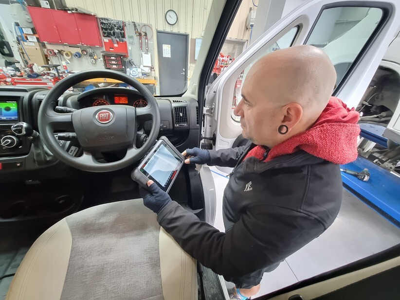 A mechanic inspecting a motorhome