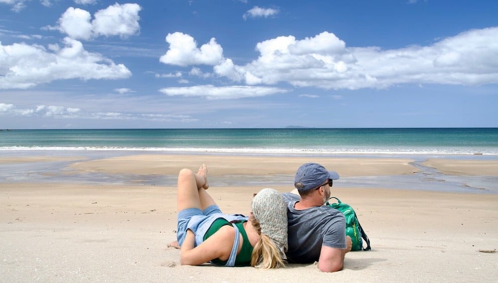 Spring beach with a couple lying down