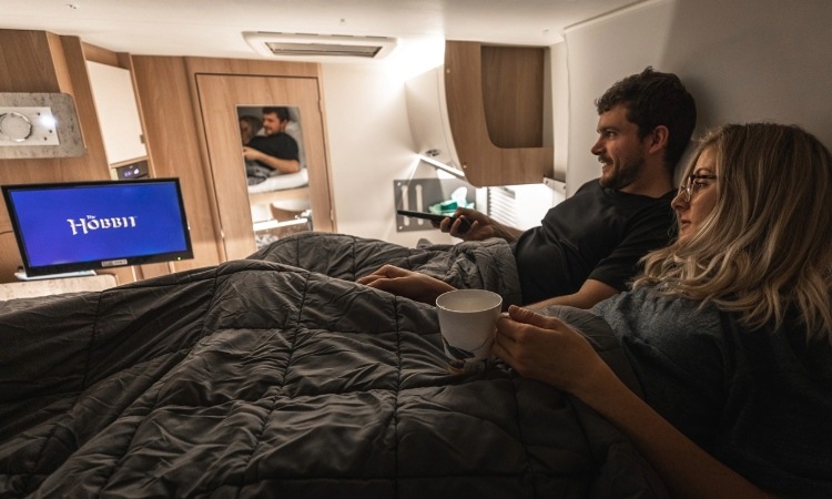 A couple watching TV in their motorhome 