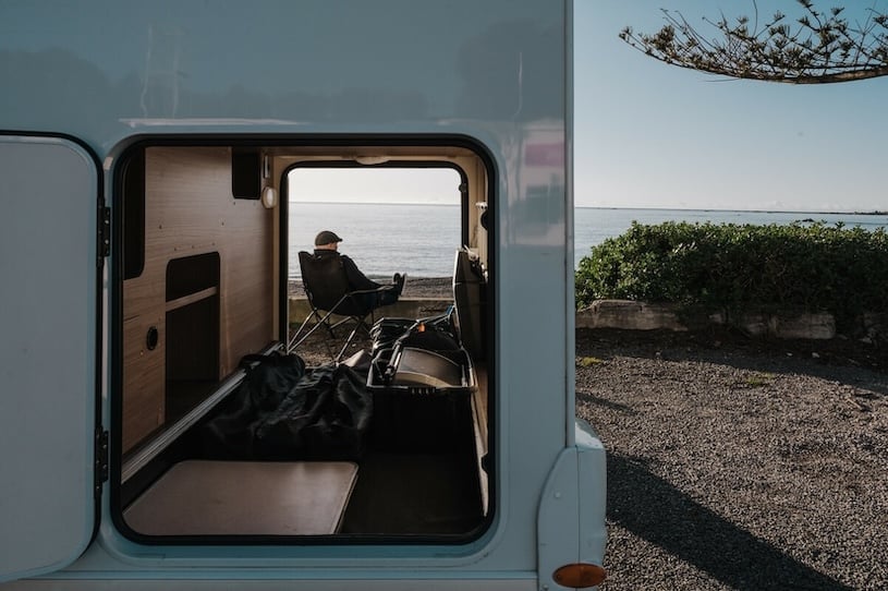 Man sitting by his motorhome with the garage open