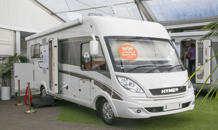 A HYMER motorhome on display at a motorhome show with a prize sticker on the windscrees