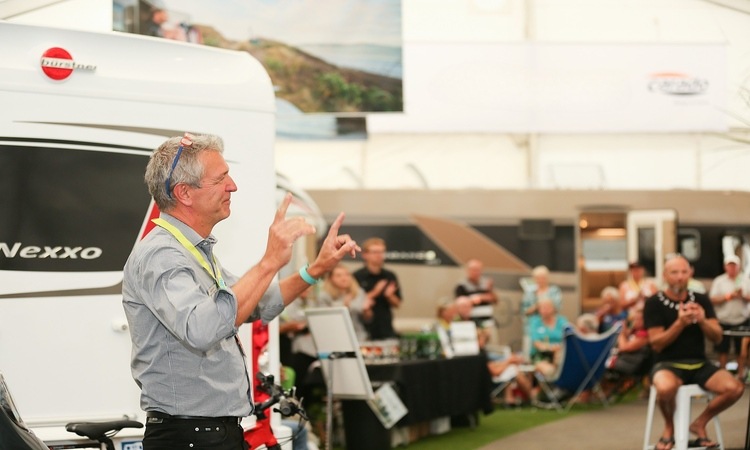 A motorhome expert hosting an informative motorhome seminar at a motorhome show