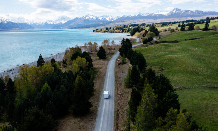 A diesel-powered motorhome travelling on a long road