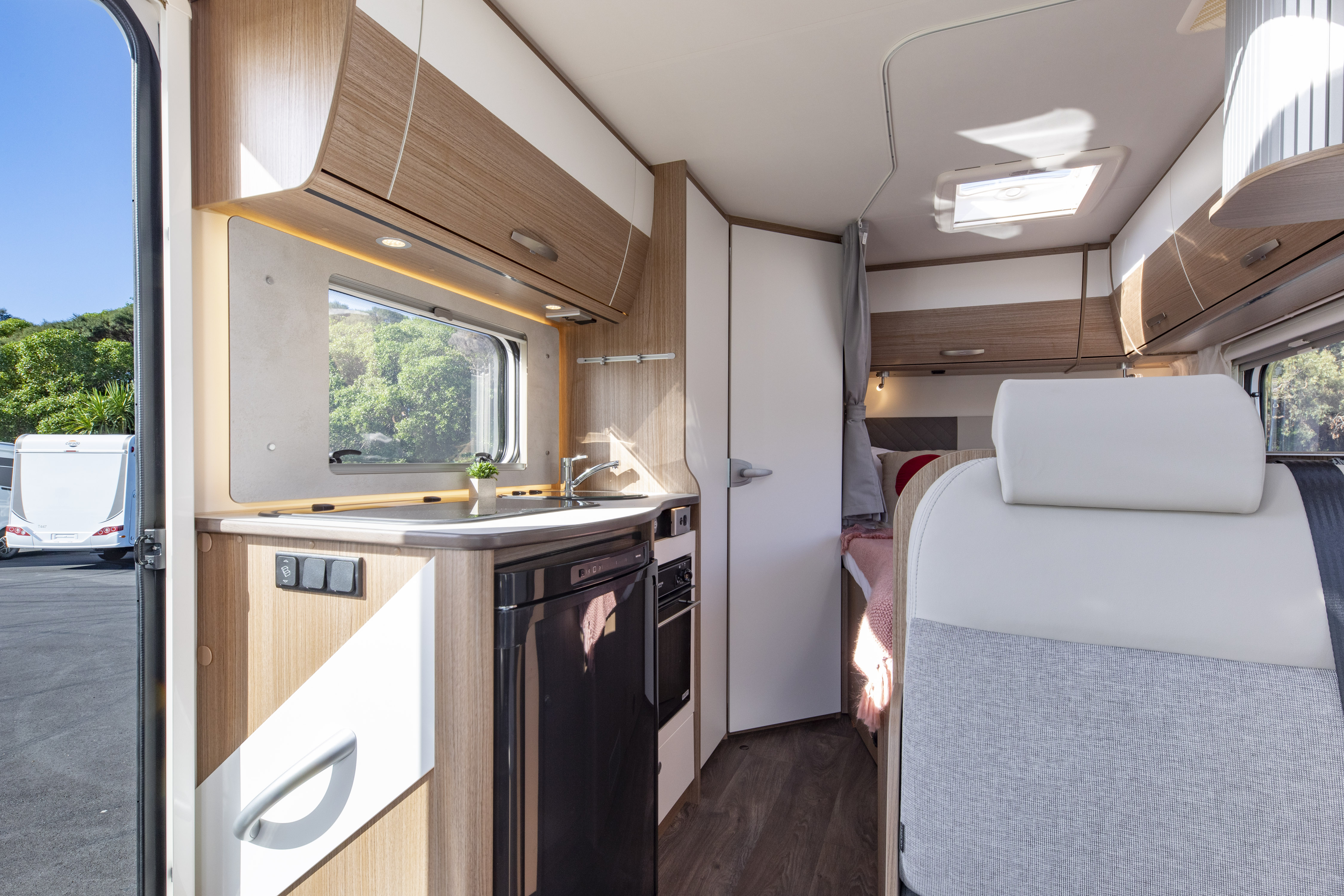 Wilderness 2022 Carado T135 motorhome interior dining to kitchen