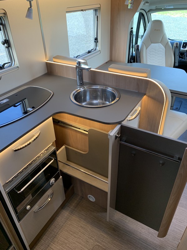 Wilderness 2019 Lyseo T734 motorhome interior kitchen cupboards open